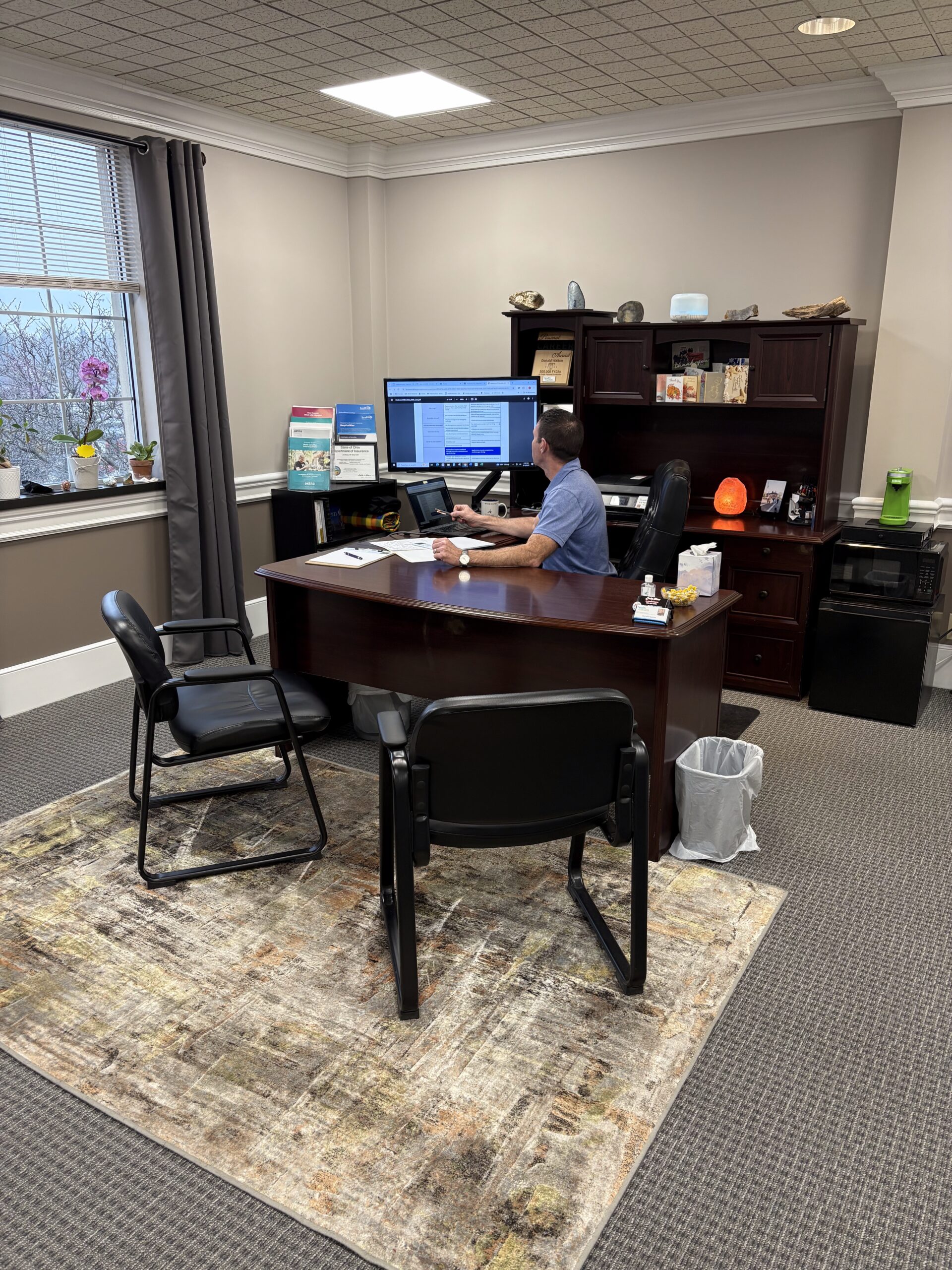 Don Walton speaking with attendees at a community event, promoting local insurance services in Wooster, Ohio